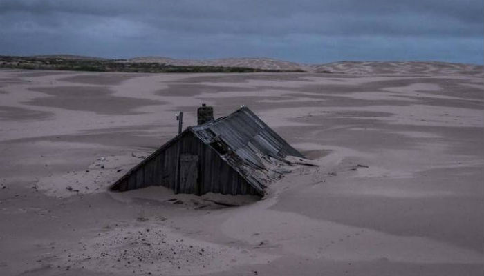 صورة تظهر سطح منزل فقط في قرية "شوينا" الغارقة تحت الرمال في روسيا.