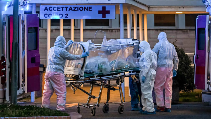 طاقم طبي ينقل مصابا بكورونا إلى مستشفى جامعة أغوستينو جيميللي في روما (أ.ف.ب)