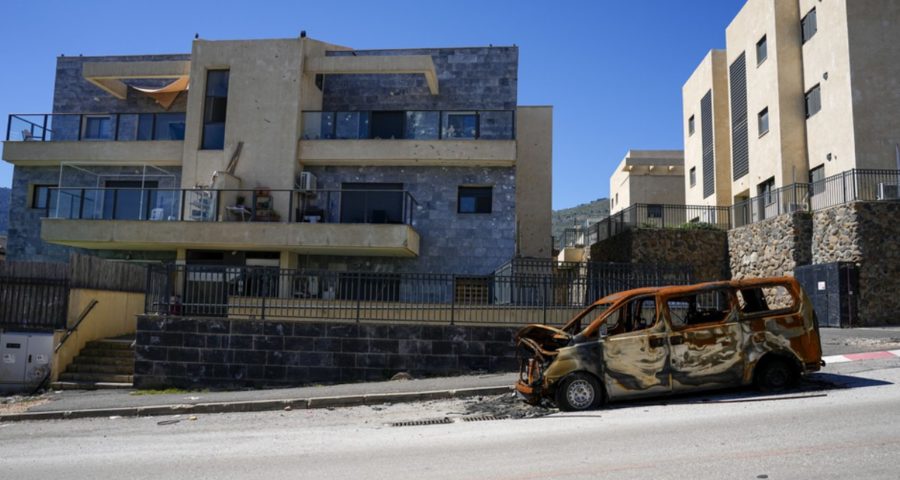A burnt car and damage to apartments from rockets fired by Hezbollah in Kiryat Shmona