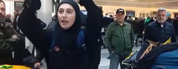 Girl Holding Nasrallah Photo in Beirut Aiport (Screenshot_Janoubia)