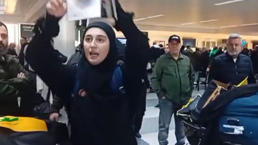 Girl Holding Nasrallah Photo in Beirut Aiport (Screenshot_Janoubia)