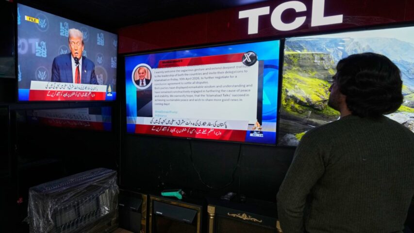 A Pakistani watches news channels telecasting report about Iran, the United States and Israel reaching a two-week ceasefire (AP)