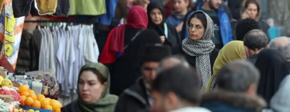 People walk while shopping in a street in Tehran, Iran, 13 January 2025 (EPA)