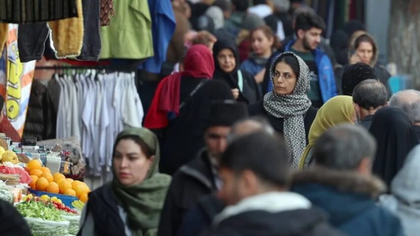 People walk while shopping in a street in Tehran, Iran, 13 January 2025 (EPA)